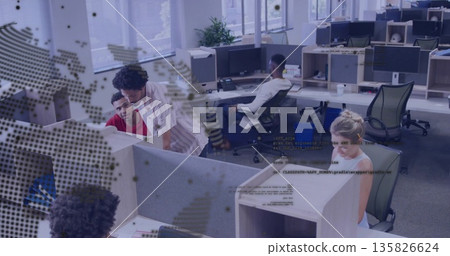 Pointing woman in striped shirt showing male coworker in red shirt at cubicle, computer monitors Pointing woman in striped shirt showing male coworker in red shirt at cubicle, computer monitors 135826624