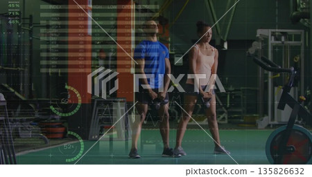 Fitness duo performing kettlebell deadlifts at gym wearing workout outfits, with overlay graphics Fitness duo performing kettlebell deadlifts at gym wearing workout outfits, with overlay graphics 135826632