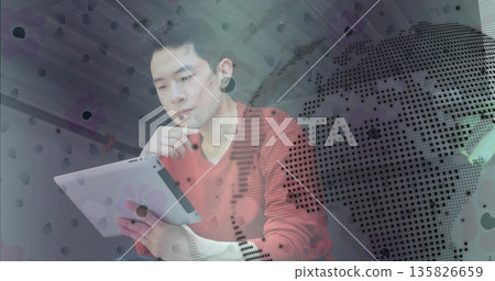 Chinese man analyzing tablet data and resting chin in modern office, with global map overlay Chinese man analyzing tablet data and resting chin in modern office, with global map overlay 135826659