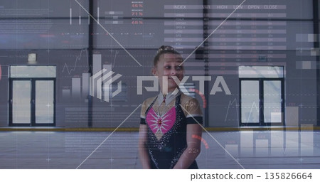 Standing female figure skater in black and pink dress on ice rink, with digital charts overlay 135826664