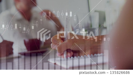 Writing hand jotting notes on spiral notebook at office meeting, with coffee cup, chart overlay Writing hand jotting notes on spiral notebook at office meeting, with coffee cup, chart overlay 135826686