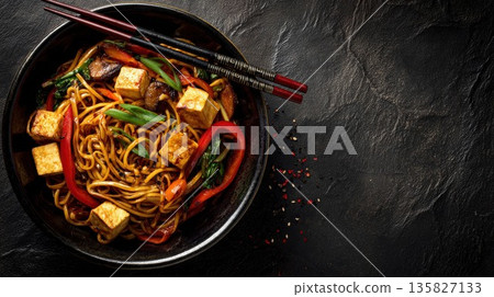 Asian stir-fried noodles with tofu and crisp vegetables in bowl Asian stir-fried noodles with tofu and crisp vegetables in bowl 135827133