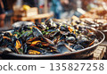 Freshly cooked mussels served in a large metal pan 135827258