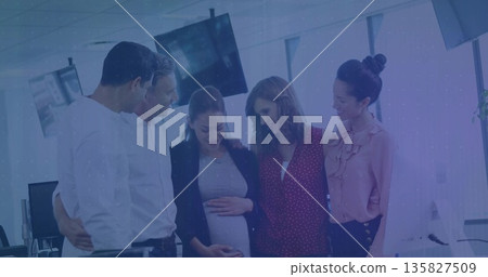 Gathering colleagues around pregnant coworker, touching belly near monitors in open office Gathering colleagues around pregnant coworker, touching belly near monitors in open office 135827509