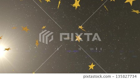 Drifting golden star-shaped confetti pieces through celestial backdrop, with bright light flare Drifting golden star-shaped confetti pieces through celestial backdrop, with bright light flare 135827734