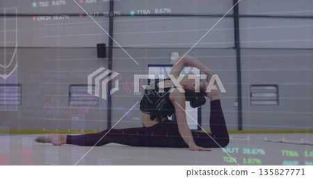 Stretching teenage gymnast holding deep front split on padded mat in sports hall with data overlay Stretching teenage gymnast holding deep front split on padded mat in sports hall with data overlay 135827771