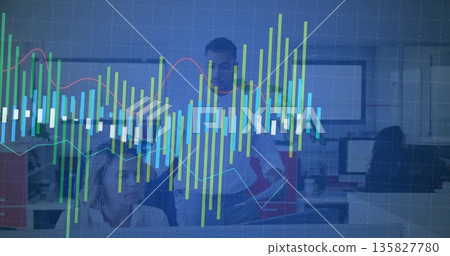 Pointing team members in suits reviewing chart overlay in office, with monitors and keyboards Pointing team members in suits reviewing chart overlay in office, with monitors and keyboards 135827780