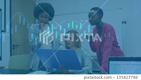 Analyzing charts by three women around conference table with whiteboard, blue folder and coffee mug 135827798