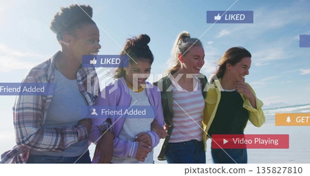 Four friends strolling arm in arm on sandy beach, with Liked Friend-Added Playing icons floating Four friends strolling arm in arm on sandy beach, with Liked Friend-Added Playing icons floating 135827810