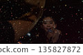 Performing female vocalist singing into wired microphone on stage with confetti, brass, copy space 135827872