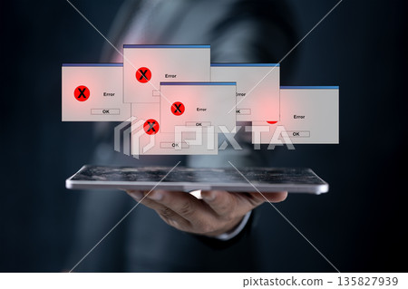 A professional businessman holds a tablet device showing several computer error windows and pop-ups, symbolizing system failure, malware infection, or technical software issues 135827939