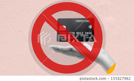 Conceptual image of a red prohibition sign over a black credit card being held in a hand, symbolizing debt freedom, payment decline, or financial restriction 135827962