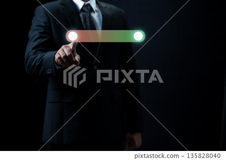 A businessman in a suit provides negative feedback by touching a sad face icon on a digital rating bar. Concept for customer service evaluation, user experience survey, and negative reviews A businessman in a suit provides negative feedback by touching a sad face icon on a digital rating bar. Concept for customer service evaluation, user experience survey, and negative reviews 135828040