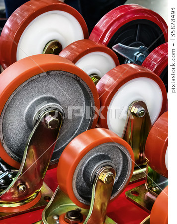 Different types of caster wheels arranged for display in a workshop setting Different types of caster wheels arranged for display in a workshop setting 135828493
