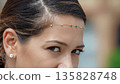 Close-up of a woman wearing a hair accessory 135828748