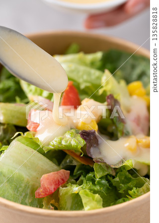 Healthy vegetable salad in takeout bowl with salad dressing ready to eating Healthy vegetable salad in takeout bowl with salad dressing ready to eating 135828818