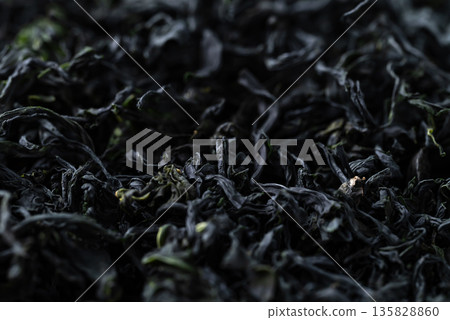 Close up of dried Wakame seaweed texture background, Organic Asian food ingredient Close up of dried Wakame seaweed texture background, Organic Asian food ingredient 135828860