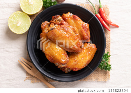 Top view of grilled New Orleans chicken wings on a black plate 135828894