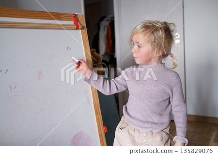 Smart preschool child pretending to be a teacher, early education and homeschooling concept. 135829076