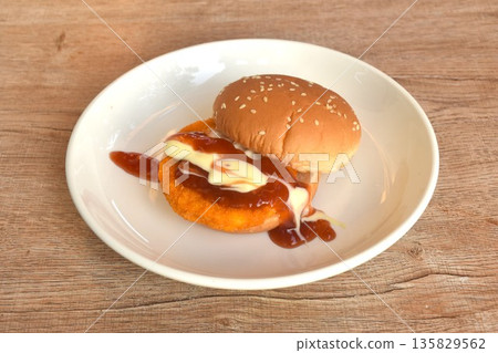 fried spicy mashed chicken hamburger dressing mayonnaise and ketchup sauce on plate  135829562