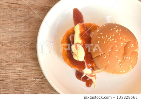 fried spicy mashed chicken hamburger dressing mayonnaise and ketchup sauce on plate fried spicy mashed chicken hamburger dressing mayonnaise and ketchup sauce on plate 135829563