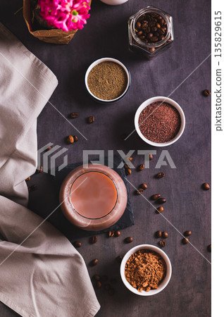 Coffee with spices and cocoa powder in a glass on the table top and vertical view Coffee with spices and cocoa powder in a glass on the table top and vertical view 135829615