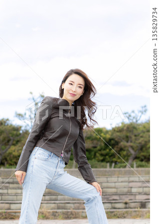 Beautiful woman walking in a city park Beautiful woman walking in a city park 135829734