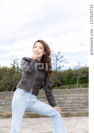 Beautiful woman walking in a city park Beautiful woman walking in a city park 135829735