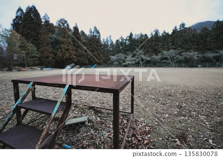 A platform remaining in a deserted park: a scene of lost bustle and silence 135830078