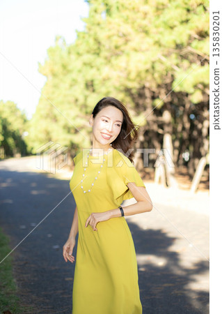 Beautiful woman walking in a city park Beautiful woman walking in a city park 135830201