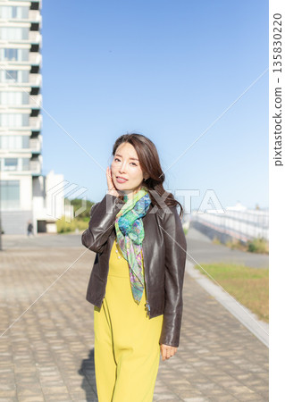 Beautiful woman walking in a city park Beautiful woman walking in a city park 135830220