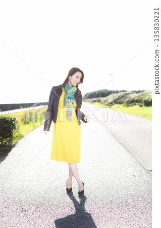 Beautiful woman walking in a city park 135830221