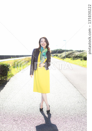 Beautiful woman walking in a city park Beautiful woman walking in a city park 135830222