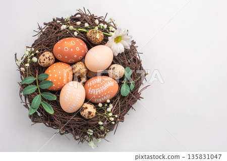 Easter nest with hand-painted eggs on a light background 135831047
