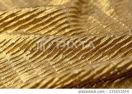 A close-up shot of gold sequin fabric 135831054