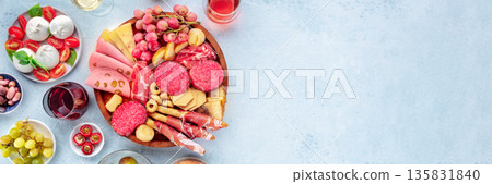 Italian Antipasti panorama. Charcuterie platter with cheese and other snacks Italian Antipasti panorama. Charcuterie platter with cheese and other snacks 135831840