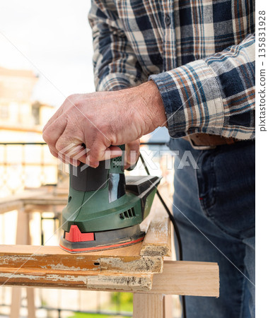 Carpenter at work, restoring an old wooden window. Carpentry. Carpenter at work, restoring an old wooden window. Carpentry. 135831928