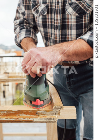 Carpenter at work, restoring an old wooden window. Carpentry. Carpenter at work, restoring an old wooden window. Carpentry. 135831931