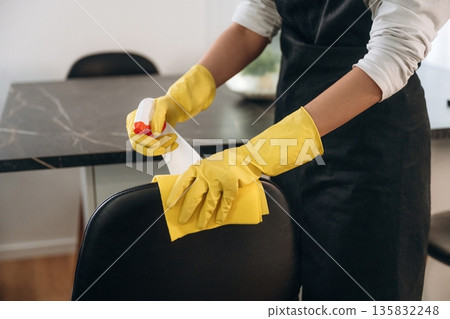 Female professional cleaning service worker is domestic room 135832248
