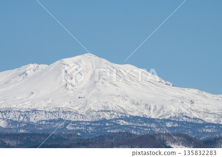 Snowy mountain peak on a sunny spring day, Mount Daisetsu Snowy mountain peak on a sunny spring day, Mount Daisetsu 135832283