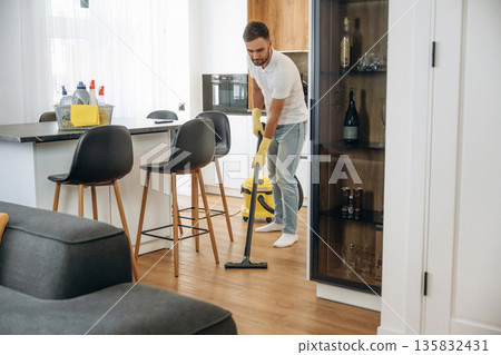 Male professional cleaning service worker is domestic room Male professional cleaning service worker is domestic room 135832431