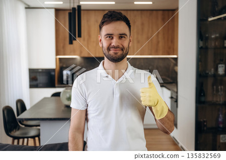 Front view, standing. Male professional cleaning service worker is domestic room Front view, standing. Male professional cleaning service worker is domestic room 135832569