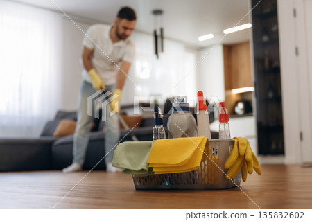 Wet cleaning of the floor. Male professional cleaning service worker is domestic room Wet cleaning of the floor. Male professional cleaning service worker is domestic room 135832602