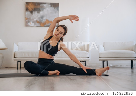 Hand up, stretching exercise. Woman with pug dog is doing yoga at home Hand up, stretching exercise. Woman with pug dog is doing yoga at home 135832956
