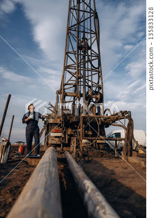 Construction worker is near boring drilling machine Construction worker is near boring drilling machine 135833128