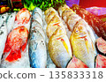 Fresh fish sale at local market in early morning. Freh seafood in ice on counter in a grocery store 135833318