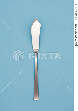 Light blue background and butter knife Light blue background and butter knife 135833631