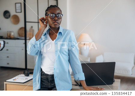 Standing, front view. Woman is at home in domestic room Standing, front view. Woman is at home in domestic room 135834417