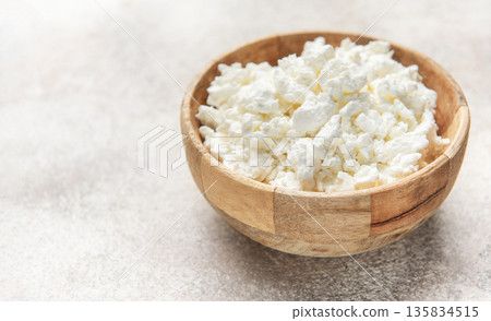 Cottage cheese in wooden bowl for healthy breakfast 135834515