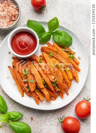 Sweet potato fries with ketchup and fresh basil Sweet potato fries with ketchup and fresh basil 135834530